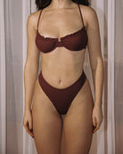 Close-up of a girl wearing a cute burgundy rib bikini.